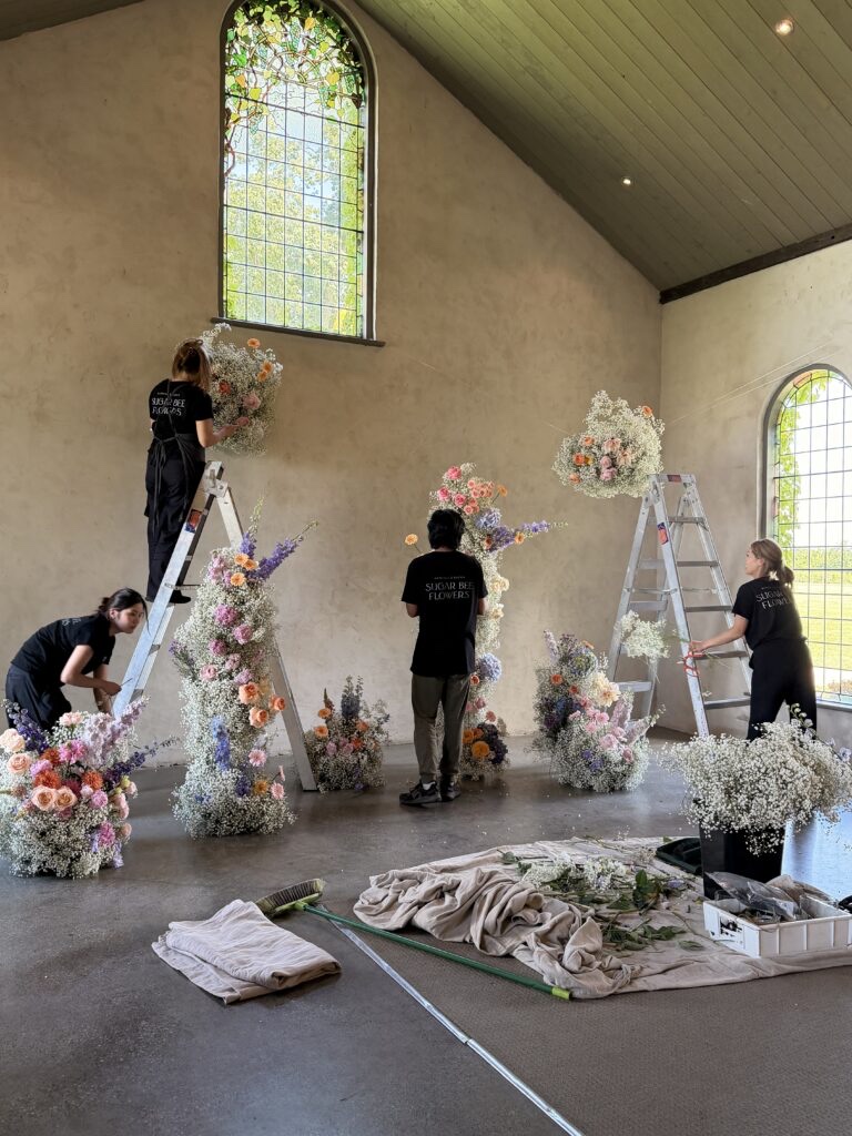 The Sugar Bee team installing florals
