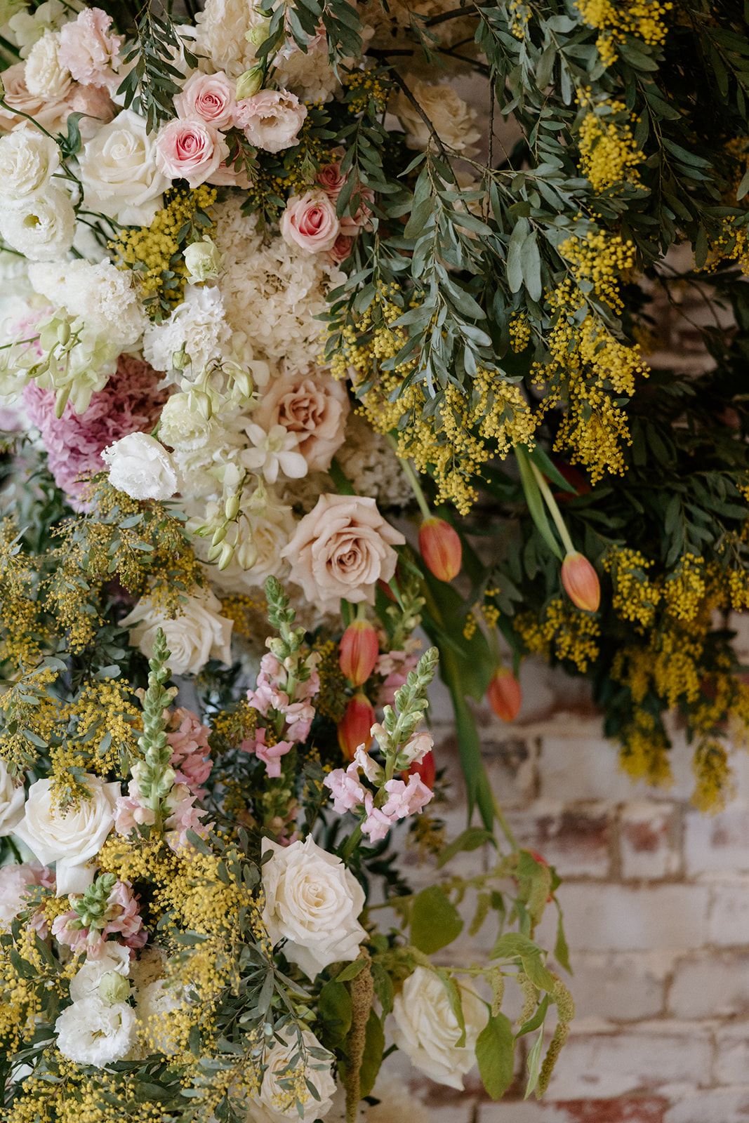 Spring wedding flowers in close-up — mimosa, blush roses, tulips and snapdragons by Sugar Bee Flowers